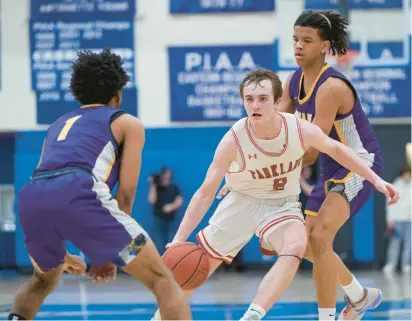  ?? DAVID GARRETT/PHOTOS SPECIAL TO THE MORNING CALL ?? Parkland’s Nick Coval goes to the basket while being defended by Roman Catholic’s Semaj Robinson in a PIAA Class 6A quarterfin­al game Saturday at Norristown High School. Parkland’s strong second half led to a 57-50 win for the Trojans.