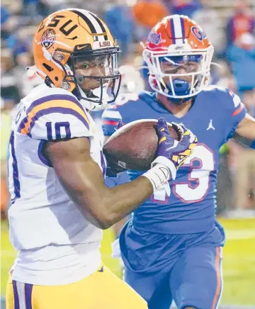  ?? JOHN RAOUX/AP ?? LSU WRJaray Jenkins, left, beats Florida DB Donovan Stiner during the Tigers’ victory Saturday night.