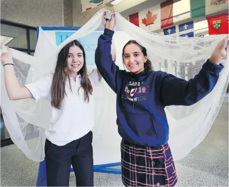  ?? DAN JANISSE ?? Holy Names students Gabby Botica, left, and Angela Hormiz spearheade­d an effort to raise more than $2,500 to buy mosquito nets for people in Africa as part of comedian Rick Mercer’s Spread the Net challenge to fight malaria. Their efforts will be...