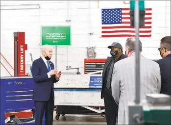  ?? NICHOLAS KAMM AFP VIA GETTY IMAGES ?? President Joe Biden tours the Kansas City Area Transporta­tion Authority in Missouri on Wednesday. Biden on Wednesday ordered steps aimed at making the federal government carbon neutral by 2050.