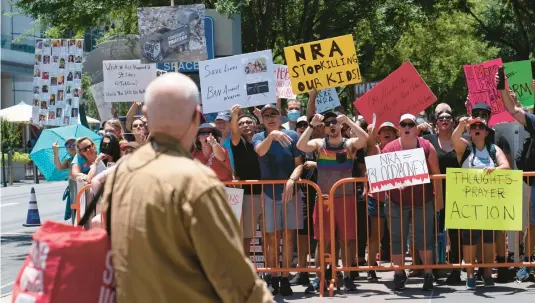  ?? JAE C. HONG/AP ?? An NRA member and protesters exchange words last week in Houston, where the gun rights advocacy group held its convention days after the mass shooting in Uvalde, Texas.