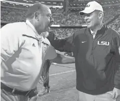  ?? JONATHAN BACHMAN, AP ?? Texas A& M defensive coordinato­r John Chavis, left, with LSU head coach Les Miles, made $ 1.5 million in 2015.