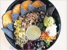  ?? SPECIAL TO THE EXAMINER ?? Copper Branch's Aztec bowl has sweet potato, corn and mango salsa, non-GMO black beans, guacamole, vegan sour cream, broccoli, beets, carrot, lettuce, organic sprouted mung beans, pumpkin seeds, and organic corn chips with brown rice.