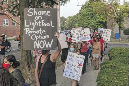  ?? TYLER LARIVIERE/SUN-TIMES ?? Around 40 parents, teachers and students march on Monday toward Mayor Lori Lightfoot’s home in Logan Square, demanding that Chicago Public Schools have remote learning options.