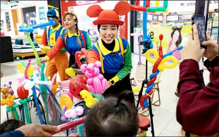  ?? — Bernama photo ?? (From left) Muhammad Al-Hazim, Nor Aina Natasya and Nor Farah Hanim entertain the children during an event.