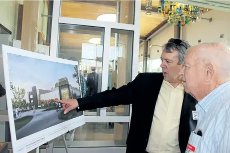  ?? PENNY COLES/POSTMEDIA NEWS ?? After Wednesday's official opening of the Lakeview Wine Co. tasting and retail centre in Niagara-on-the-Lake, Murray Souter, president and CEO of Diamond Estates, shows his father Leslie Souter plans for the second phase of expansion, which will...