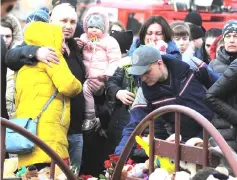  ??  ?? People mourn the victims of the shopping mall fire at a makeshift memorial in Kemerovo. — Reuters photo