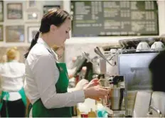  ?? — Reuters ?? A female barista works at Starbucks store in New York.