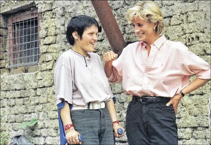  ?? AP fiLe PhoTo ?? In this photo from 1997, Britain’s Diana, Princess of Wales (right) chats with 15-year-old landmine victim Bosnian muslim girl Mirzeta Gabelic, in front of Mirzeta’s home in Sarajevo, while Diana was on a visit to the region as part of her campaign...