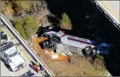  ?? ASSOCIATED PRESS ?? RESCUE CREWS WORK AT THE SCENE crash on Tuesday in Loxley, Ala. of a deadly charter bus