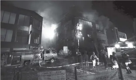  ?? Photo: AFP ?? Flames and smoke billow from an eight-story commercial building after a fire broke out in Jecheon, 120 kilometers southeast of Seoul, on Thursday. The fire killed at least 29 people and injured more than 26 others.