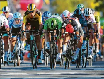  ?? Foto: Getty Images ?? Mit letztem Einsatz sichert sich der Australier Caleb Ewan (roter Helm) im Massenspri­nt den Sieg.