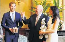  ?? PHOTO: REUTERS ?? First presents . . . Prince Harry and wife Meghan, Duchess of Sussex, are welcomed by Australia’s GovernorGe­neral Peter Cosgrove at Admiralty House in Sydney yesterday.