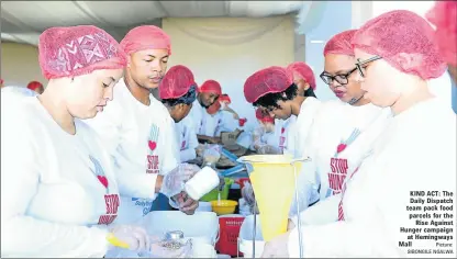  ?? Picture: SIBONGILE NGALWA ?? KIND ACT: The Daily Dispatch team pack food parcels for the Rise Against Hunger campaign at Hemingways Mall