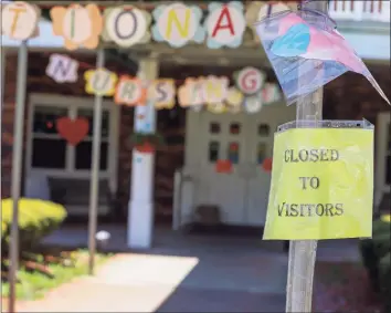  ?? Chris Ehrmann / Associated Press ?? A sign posted near the entrance to the Kimberly Hall North nursing home shows the home closed to visitors on May 14 in Windsor. All of Connecticu­t’s 200 or so nursing homes have signed on to get COVID-19 vaccinatio­ns for residents and staff as part of a priority push for vulnerable population­s, according to officials with the state Department of Public Health.