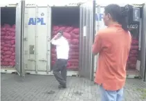  ??  ?? PHILIPPINE customs officers seize and present to media container vans of smuggled agricultur­al products at the ICTSI terminal in Manila.