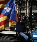  ??  ?? A farmer raises his fist at a police helicopter during a show of support for the referendum in Barcelona