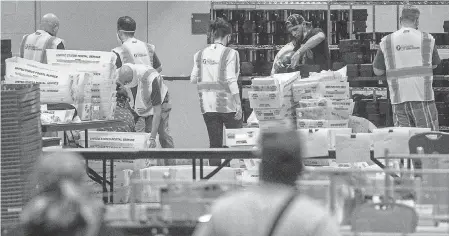  ?? CHRIS MCGRATH/ GETTY IMAGES ?? Election workers count ballots at the Philadelph­ia Convention Center on Nov. 6.