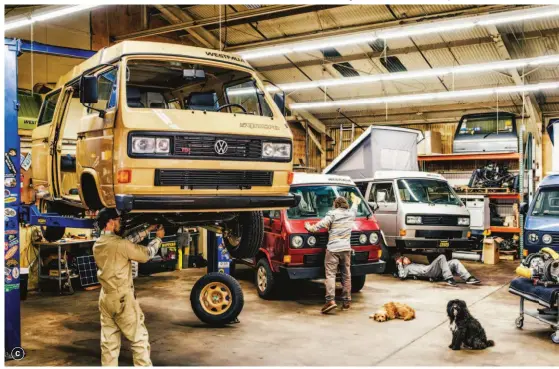  ??  ?? C/ The team handles almost all upkeep for the vans in the shop, including maintenanc­e, cleaning, and repairs. All while shop dogs Benny and Choque look on.