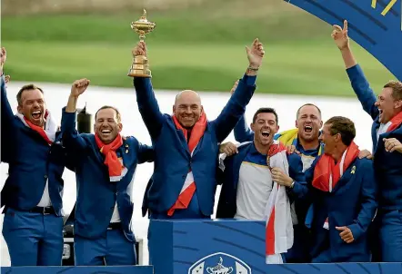  ?? MATT DUNHAM/AP ?? Europe team captain Thomas Bjorn holds aloft the Ryder Cup after his team beat the USA 171⁄2 to 101⁄2 at Le Golf National outside of Paris yesterday.