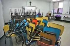  ?? AP PHOTO/JESSIE WARDARSKI ?? Desks and chairs are stacked in an empty classroom after the permanent closure of Queen of the Rosary Catholic Academy in Brooklyn borough of New York in August.