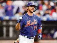  ?? Frank Franklin II / Associated Press ?? New York Mets’ Pete Alonso gestures as he runs to first base for an RBI single during the second inning in the first game of a doublehead­er against the Atlanta Braves Tuesday in New York.