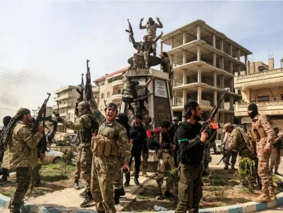  ??  ?? Turkish-backed Free Syrian Army soldiers celebrate victory in the northern city