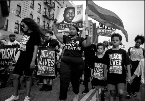  ?? CRAIG RUTTLE / ASSOCIATED PRESS FILE (2019) ?? Activists with Black Lives Matter protest July 16, 2019, in the Harlem neighborho­od of New York, in the wake of a decision by federal prosecutor­s who declined to bring civil rights charges against New York City police Officer Daniel Pantaleo, in the 2014 chokehold death of Eric Garner.