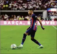  ?? Ethan Miller / Getty Images ?? Barcelona’s Raphinha dribbles the ball against Real Madrid during their preseason friendly match at Allegiant Stadium on July 23 in Las Vegas.