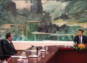  ?? AP/FRED DUFOUR ?? China’s President Xi Jinping (right) talks Friday with North Korean Foreign Minister Ri Yong Ho at the Great Hall of the People in Beijing.