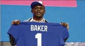  ?? MARK HUMPHREY/ ASSOCIATED PRESS ?? Former Georgia cornerback Deandre Baker poses with his new jersey after the Giants selected him in the first round April 25, 2019, in Nashville, Tenn. Baker, who started 15 games in his rookie season, was released in September.