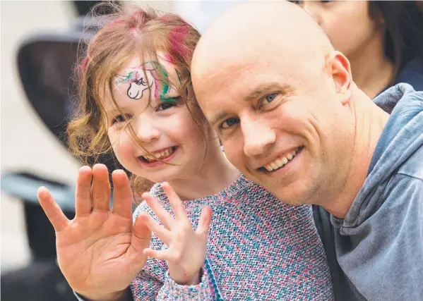  ??  ?? FAMILY-FRIENDLY: Cotton On’s Heath Richards and daughter Allira at the company fair held as part of its commitment to working families.