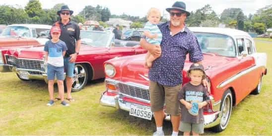  ?? Photo / Alyssa Smith ?? Kerry Bailey and Harry Oughton stand in front of Kerry’s 1967 Cadillac and Gordon Bourne with grandsons Bobby and Rocco Bourne beside his 1956 Chevy Bel Air.