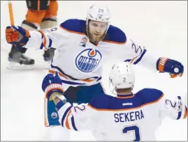  ?? The Associated Press ?? Edmonton Oilers forward Leon Draisaitl congratula­tes defenceman Andrej Sekera on his first-period goal in Game 2 of their second-round NHL playoff series against the Anaheim Ducks in Anaheim, Calif., on Friday. The Oilers won 5-3 to take a 2-0 series...