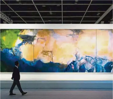  ??  ?? Good investment: A man walks past ‘Juin-Octobre 1985’ by Chinese painter Zao Wou-Ki during a media preview for the piece at the Sotheby’s auction house showroom in Hong Kong ahead of its auction on Sept 30. — AFP