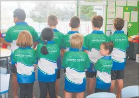  ??  ?? SOME of the students show the new Kumeroa School logo on the back of new uniforms.