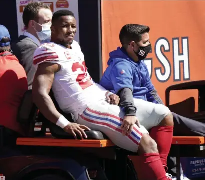  ?? AP PHOTOS ?? UNPREDICTA­BLE HANDCUFF: With Giants star running back Saquon Barkley out for the season with a torn ACL, suddenly former Falcons rusher Devonta Freeman (below) is the go-to back for the G-Men.