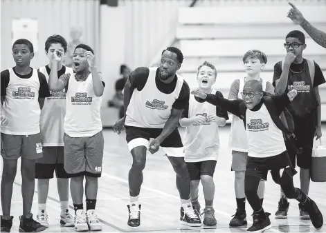  ?? Photos by Brett Coomer / Staff photograph­er ?? Clippers guard Patrick Beverley is as excited as the kids as they watch an overtime game during his annual basketball camp.