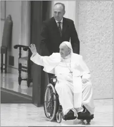  ?? GREGORIO BORGIA/AP ?? Pope Francis arrives in a wheel chair in the Paul VI hall to attend an audience with pilgrims from central Italy at the Vatican on Saturday.