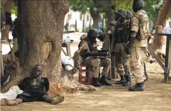  ?? Sunday Alamba / Associated Press 2009 ?? A suspected member of Boko Haram captured in 2009 by Nigerian troops lies by a tree in Maiduguri. The homegrown Islamic insurgency group marks 10 years of existence this week.