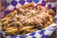  ?? Photos by John Storey / Special to The Chronicle ?? The Hank-style fries ($8.50) are topped with pulled pork and ghost pepper jack cheese.