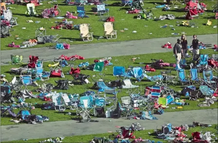  ?? MARCIO JOSE SANCHEZ/AP PHOTO ?? Investigat­ors work at a festival grounds across the street from the Mandalay Bay Resort and Casino on Tuesday in Las Vegas.