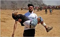  ?? AFP file ?? IT’S GONE TOO FAR: A Palestinia­n carries an injured protester during clashes with Israeli forces. —