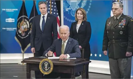  ?? Rod Lamkey Consolidat­ed News Photos ?? PRESIDENT Biden is joined by Secretary of State Antony J. Blinken, left, Deputy Secretary of Defense Kathleen Hicks and Chairman of the Joint Chiefs of Staff Army Gen. Mark A. Milley as he signs a bill last month on the assistance the United States is providing to Ukraine.