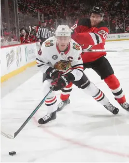  ?? GETTY IMAGES ?? Jonathan Toews is pursued by Devils right wing Blake Coleman on Monday.