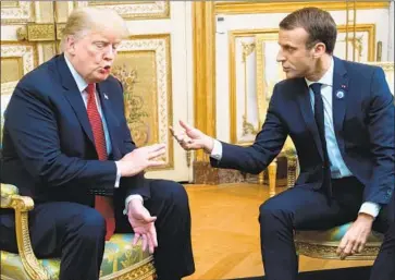  ?? Saul Loeb AFP/Getty Images ?? PRESIDENT TRUMP and French President Emmanuel Macron in Paris this month. Trump incorrectl­y said that Macron had suggested Europe build its own military to protect itself from the U.S., China and Russia.