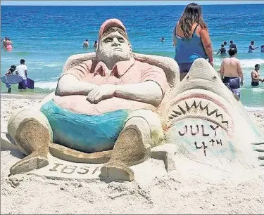  ??  ?? SAND BLASTED: A Seaside Heights sand sculpture by artists known only as Larry and Tom mocks Gov. Chris Christie on Tuesday, capturing his now-infamous pose on a beach closed to the public.