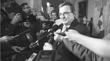  ?? SEAN KILPATRICK/ THE CANADIAN PRESS ?? Finance Minister Jim Flaherty speaks to reporters outside the House of Commons on Monday.