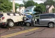  ?? EVAN BRANDT — DIGITAL FIRST MEDIA ?? Goodwill medic Kevin Yerger consults with police before transporti­ng the driver of the Mazda to Pottstown Hospital after the accident Tuesday, June 26.