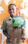  ??  ?? Jadon Smith, Grade 5 student of the Newstead Primary School, St Mary, shows a globe he made from recycled material.